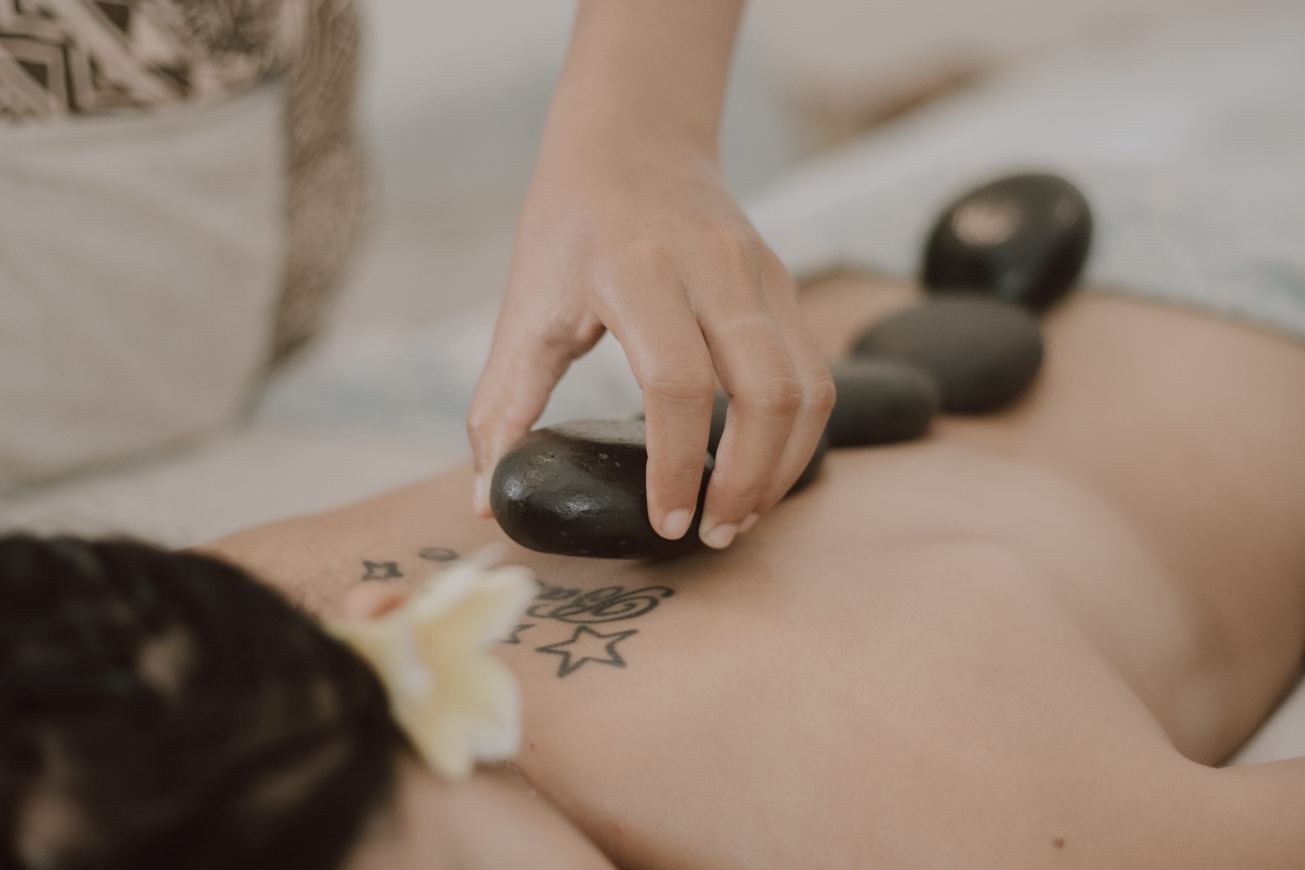 Hot stone body massage by therapist at Jaens Spa Ubud Bali