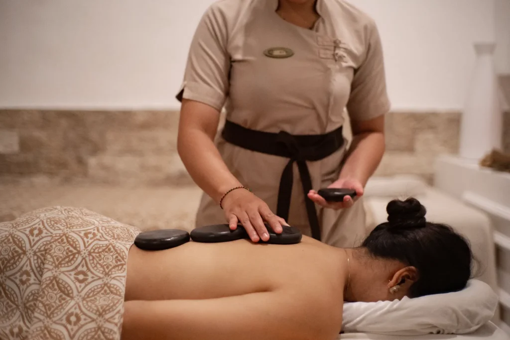 Jaens Spa Ubud treatment room with massage table natural candles and fresh flowers